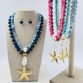Set de aretes y collar doble con dije de estrella de mar